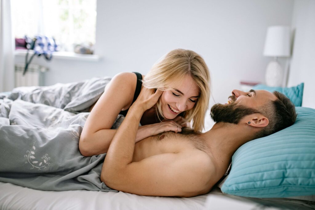 A couple laughing in bed
